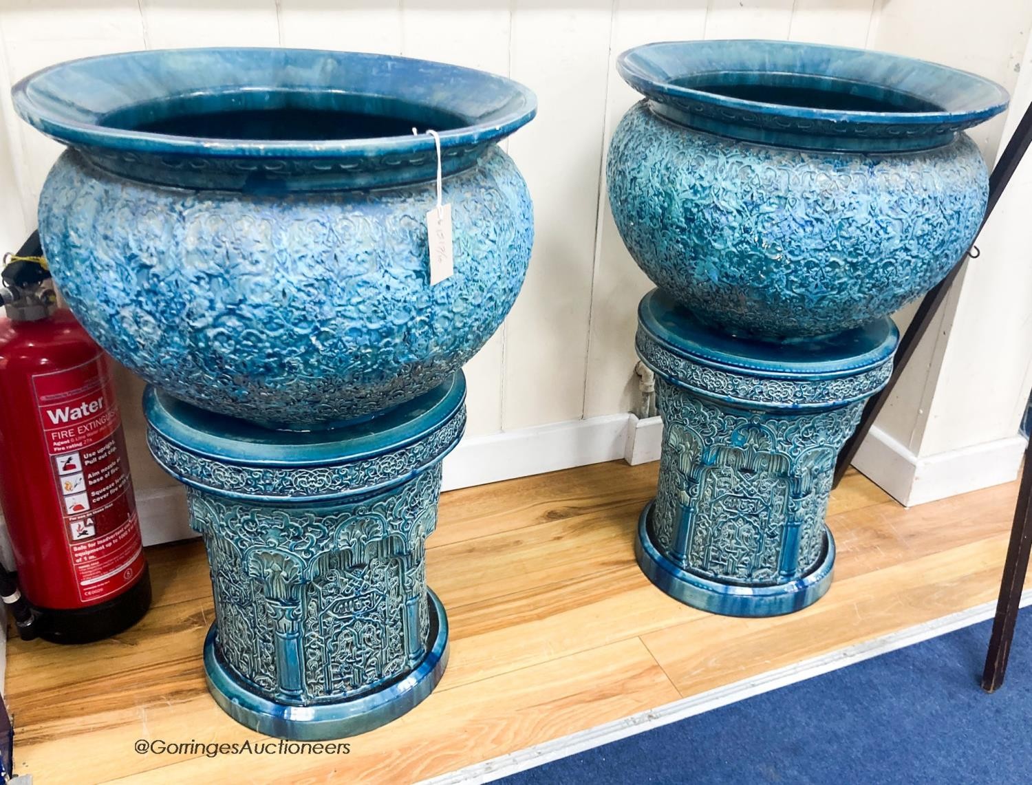 A pair of large Burmantofts style blue glazed moorish design jardinieres and stands- ex Christies Wentworth auction